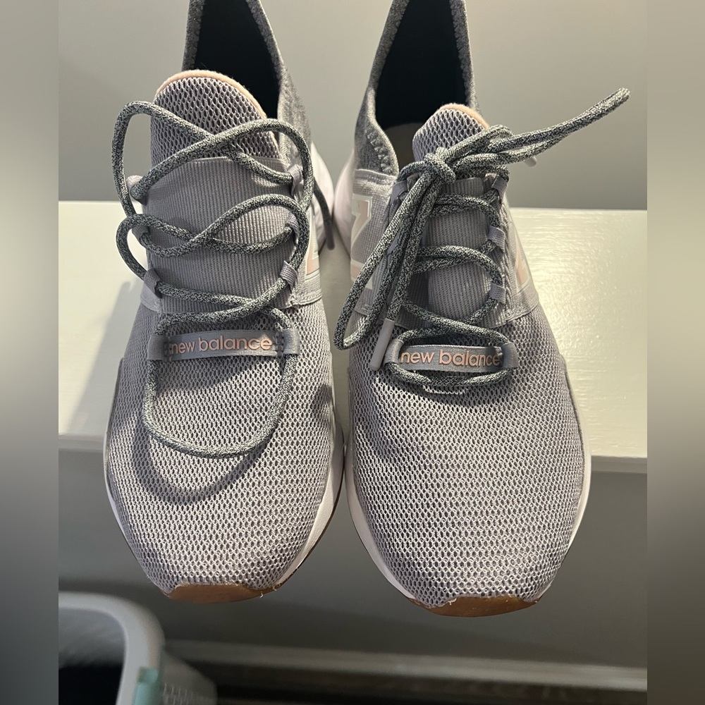 Gray and Pink New Balance tennis shoes.